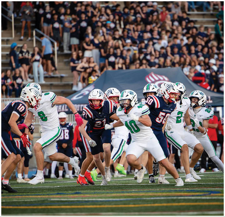 A group of football players on a field. Description generated by AI