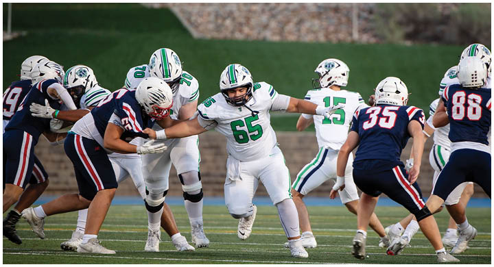 A group of football players on a field. Description generated by AI