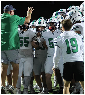 A group of football players celebrating a touchdown. Description generated by AI