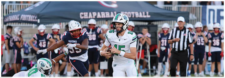 A football game is taking place on a field with players wearing blue and white uniforms. Description generated by AI