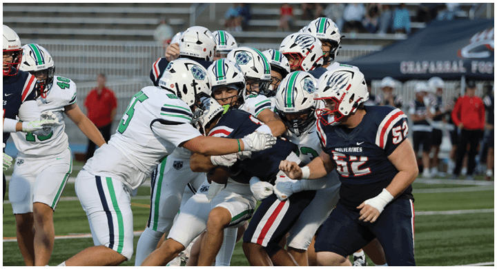 A group of football players on a field. Description generated by AI