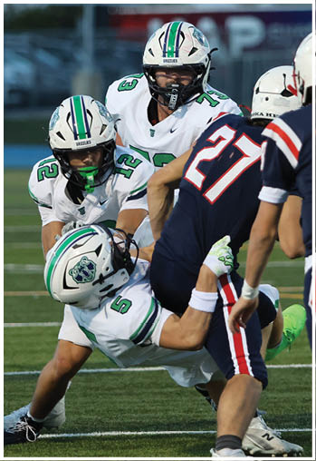 A group of football players celebrating a touchdown. Description generated by AI