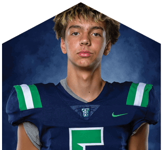 A young man wearing a white jersey with the number 10 on it. Description generated by AI