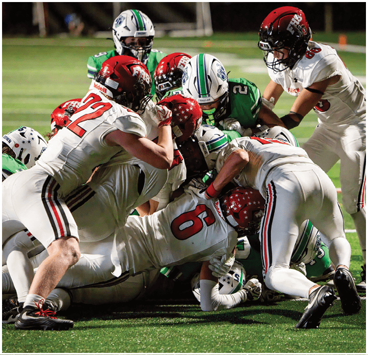 A group of football players on a field. Description generated by AI