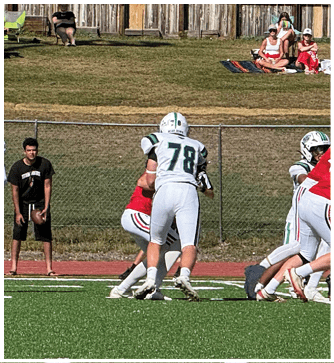 A football game is being played on a field. Description generated by AI