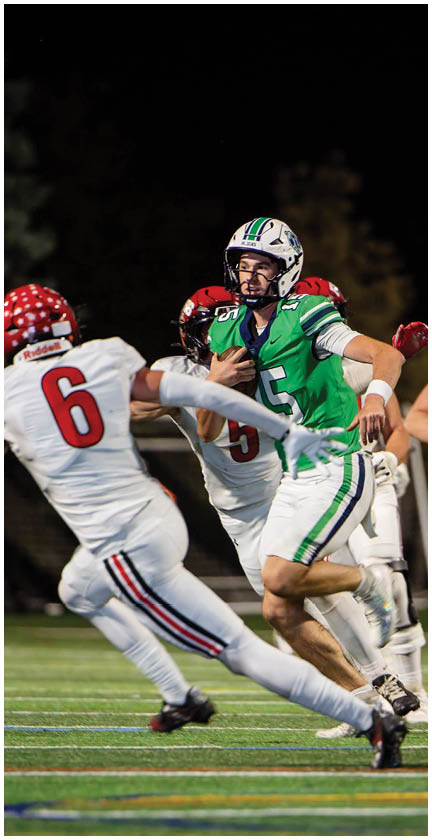 A football player wearing a blue and red jersey. Description generated by AI