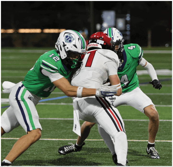 A group of football players on a field. Description generated by AI