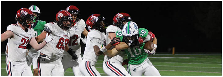 A football game is taking place on a field with players wearing blue and white uniforms. Description generated by AI