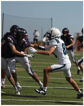 A football game is being played on a field. Description generated by AI