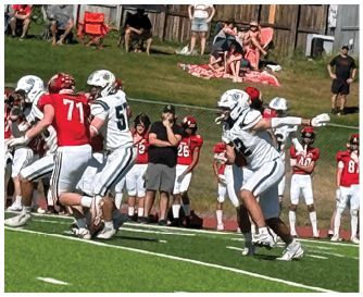 A football game is being played on a field. Description generated by AI