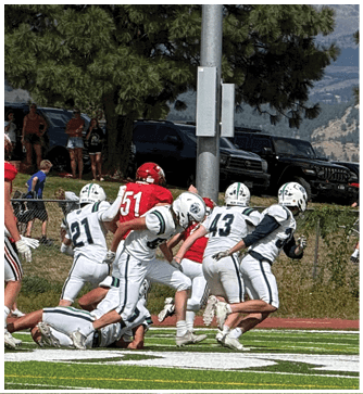 A football game is being played on a field. Description generated by AI