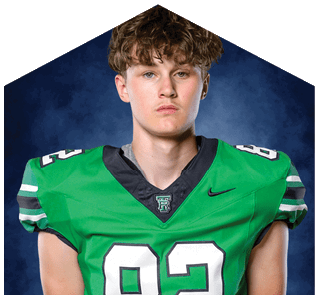 A young man wearing a white jersey with the number 10 on it. Description generated by AI