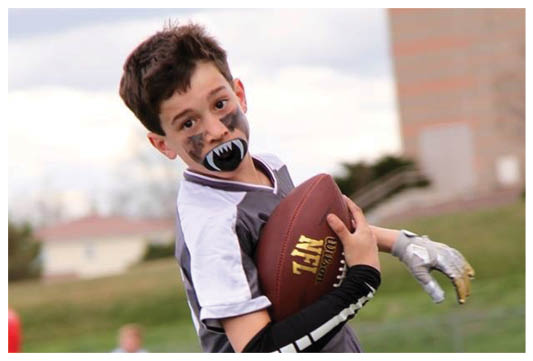 A football player wearing a blue and red jersey. Description generated by AI