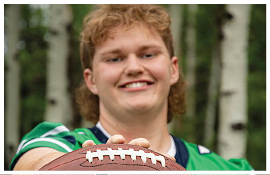 A football player wearing a blue and red jersey. Description generated by AI