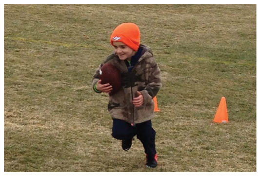 A football player wearing a blue and red jersey. Description generated by AI