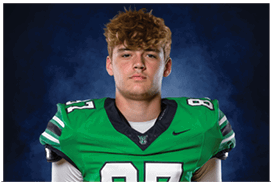 A young man wearing a white jersey with the number 10 on it. Description generated by AI