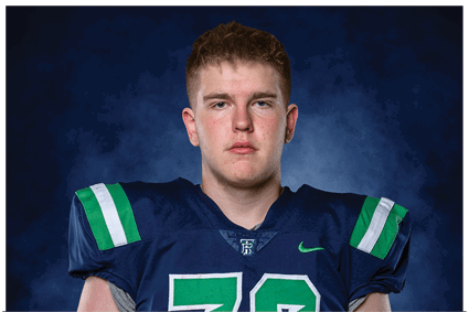 A young man wearing a white jersey with the number 10 on it. Description generated by AI