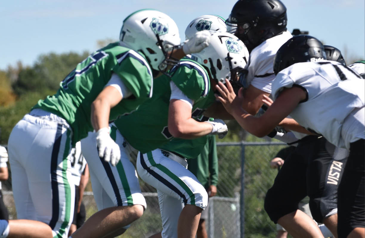 A group of people wearing black and white uniforms. Description generated by AI