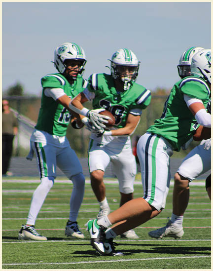 A group of football players on a field. Description generated by AI