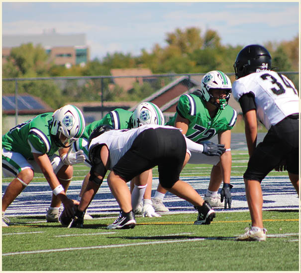 A group of football players on a field. Description generated by AI