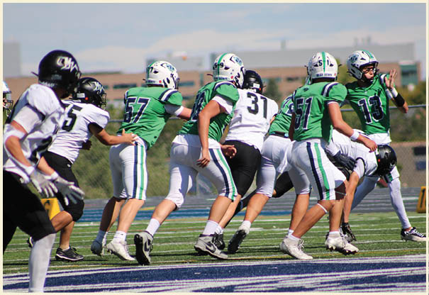 A group of football players posing for a picture. Description generated by AI