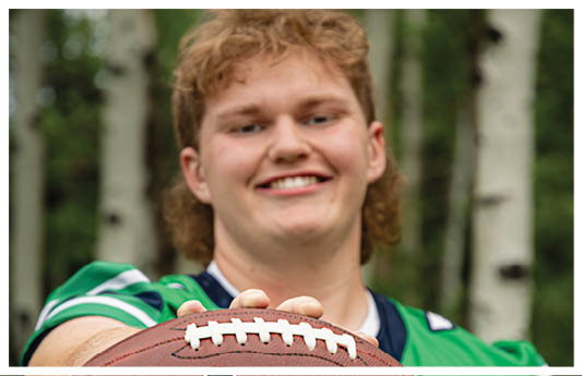 A football player wearing a blue and red jersey. Description generated by AI