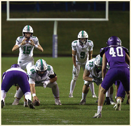 A football player is kicking a football on a field. Description generated by AI