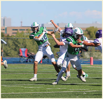 A group of football players posing for a picture. Description generated by AI