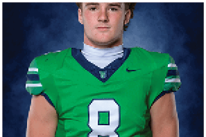 A young man wearing a white jersey with the number 10 on it. Description generated by AI