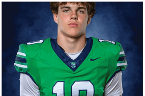 A young man wearing a white jersey with the number 10 on it. Description generated by AI