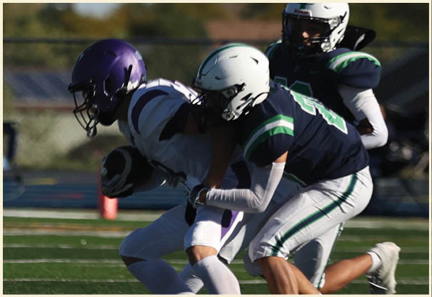 A group of football players posing for a picture. Description generated by AI