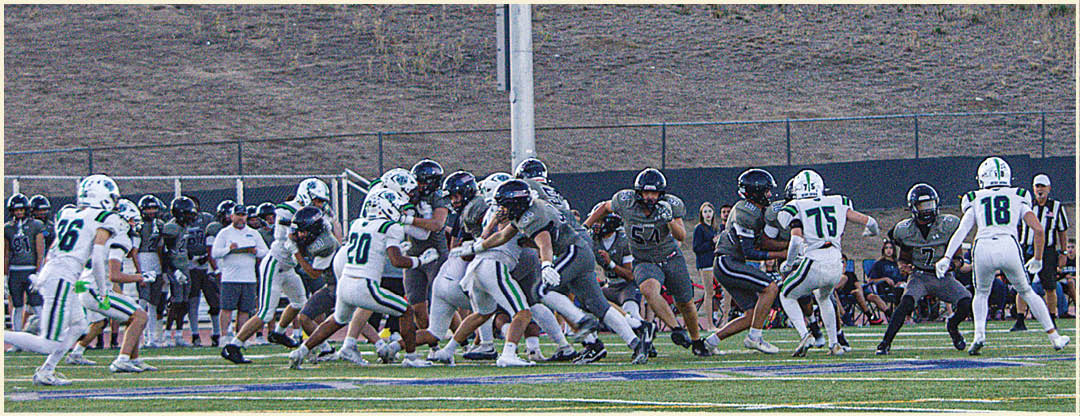 A group of football players posing for a picture. Description generated by AI