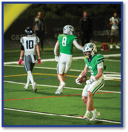 A football player wearing a black jersey with the number 6 on it. Description generated by AI