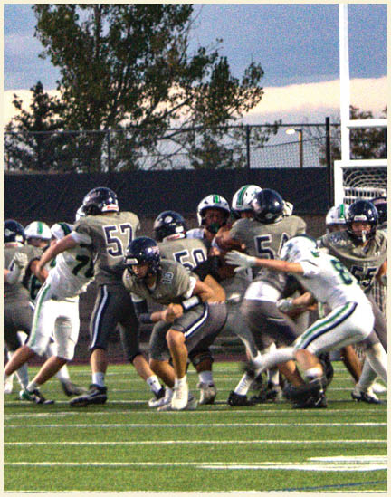 A group of football players on a field. Description generated by AI