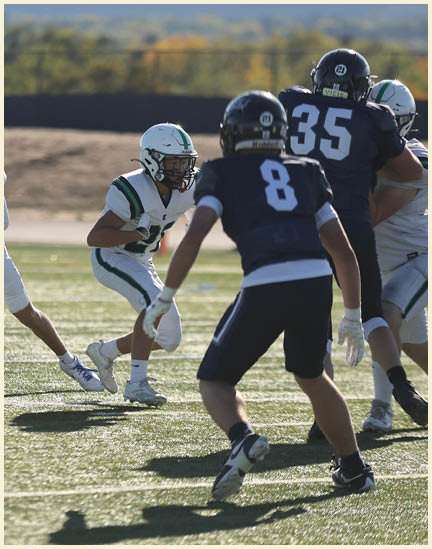 A group of football players on a field. Description generated by AI
