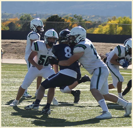 A group of football players posing for a picture. Description generated by AI