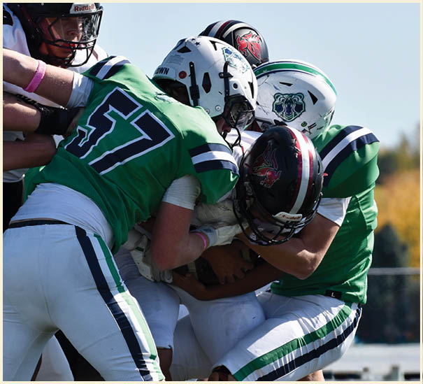 A group of football players on a field. Description generated by AI