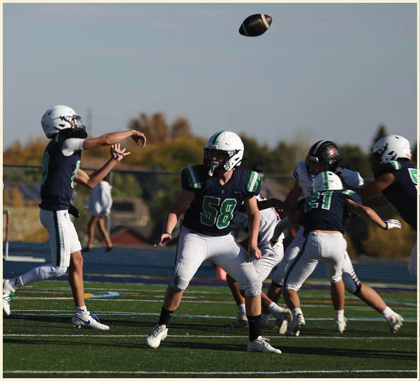 A group of football players on a field. Description generated by AI