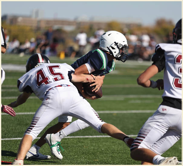 A group of football players on a field. Description generated by AI