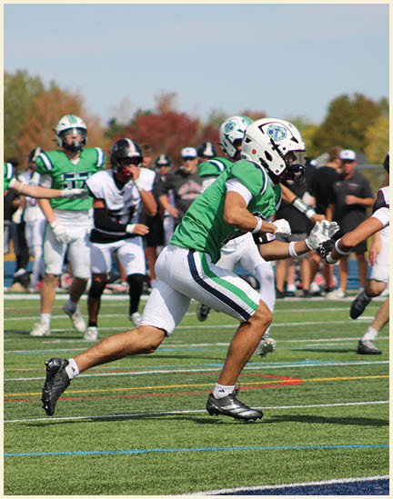 A group of football players on a field. Description generated by AI