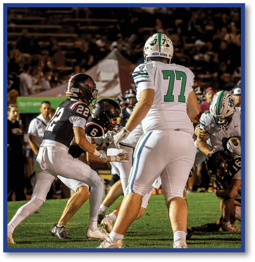 A group of men wearing black and white jerseys. Description generated by AI