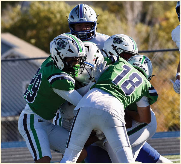 A group of football players on a field. Description generated by AI