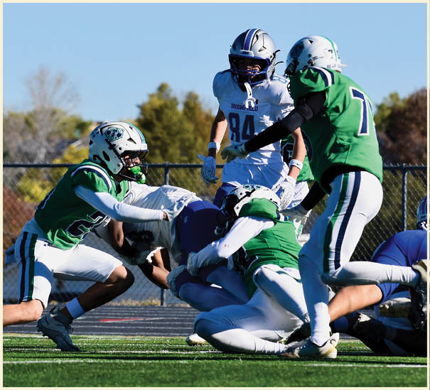 A group of football players on a field. Description generated by AI