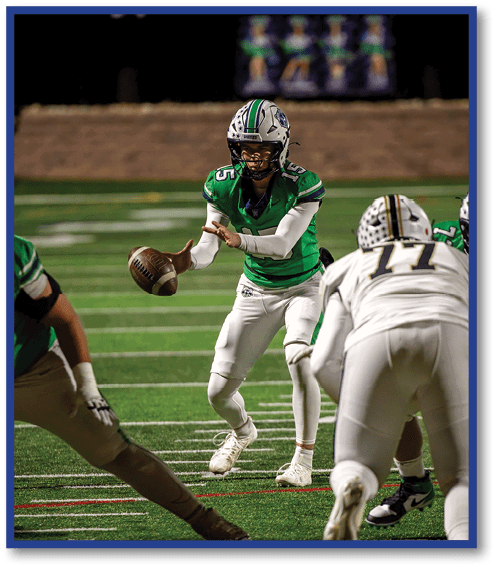 A football player wearing a black jersey with the number 6 on it. Description generated by AI