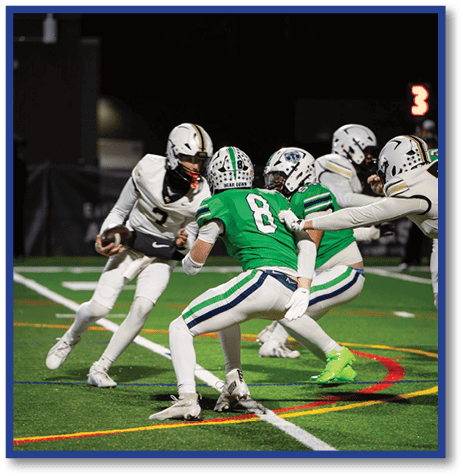 A football player wearing a black jersey with the number 6 on it. Description generated by AI