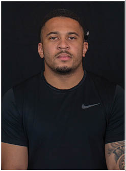 A football player running on the field. Description generated by AI