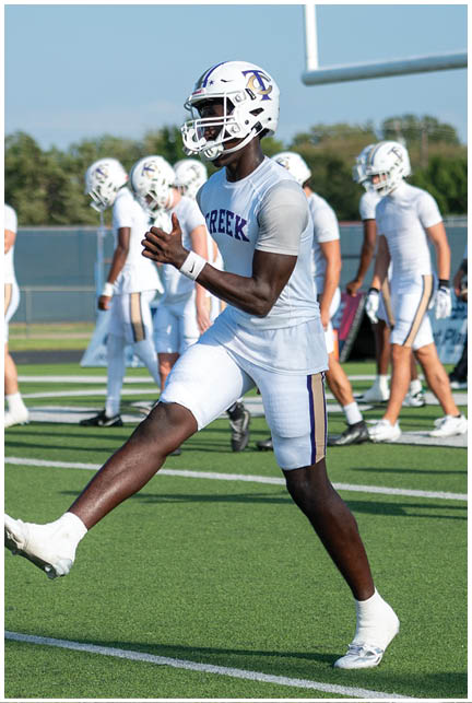 A football player wearing a blue and white uniform. Description generated by AI
