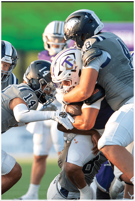 A football player wearing a blue and white uniform. Description generated by AI