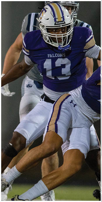 Two football players celebrating on the field. Description generated by AI