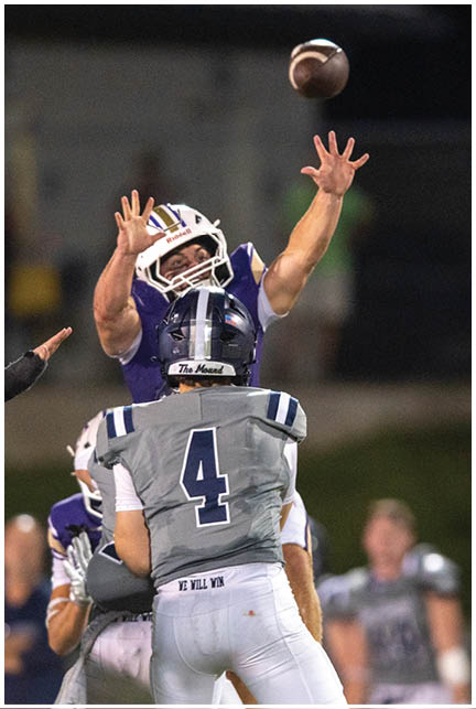 A football player wearing a blue and white uniform. Description generated by AI